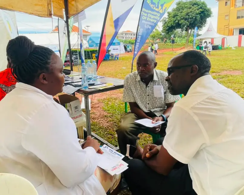 Clinicians consulting with community members at an outreach tent